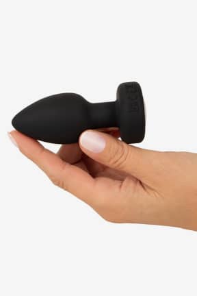 Buttplug Anos - RC Flashing Butt Plug with Vibration - Vattentät buttplug i mjuk silikon med 7 vibrationslägen och smidig fjärrkontroll. Färgglad LED i stoppet och USB-laddning för lek som känns lite extra busig.